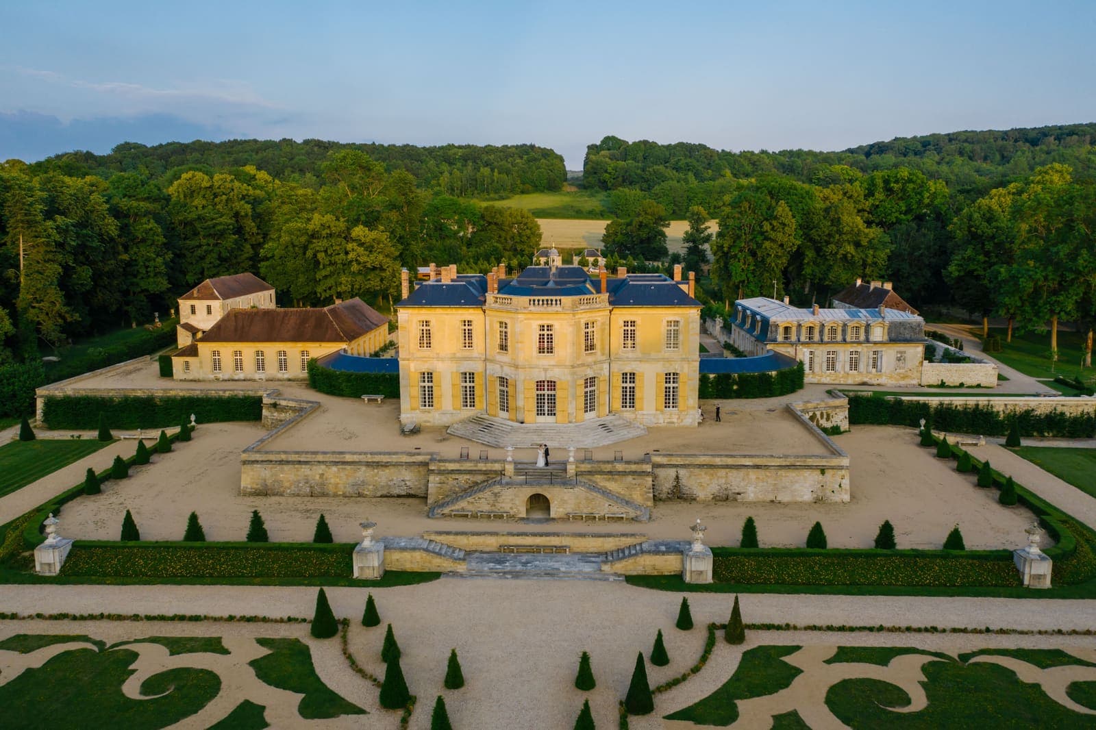 A château with formal gardens in golden evening light