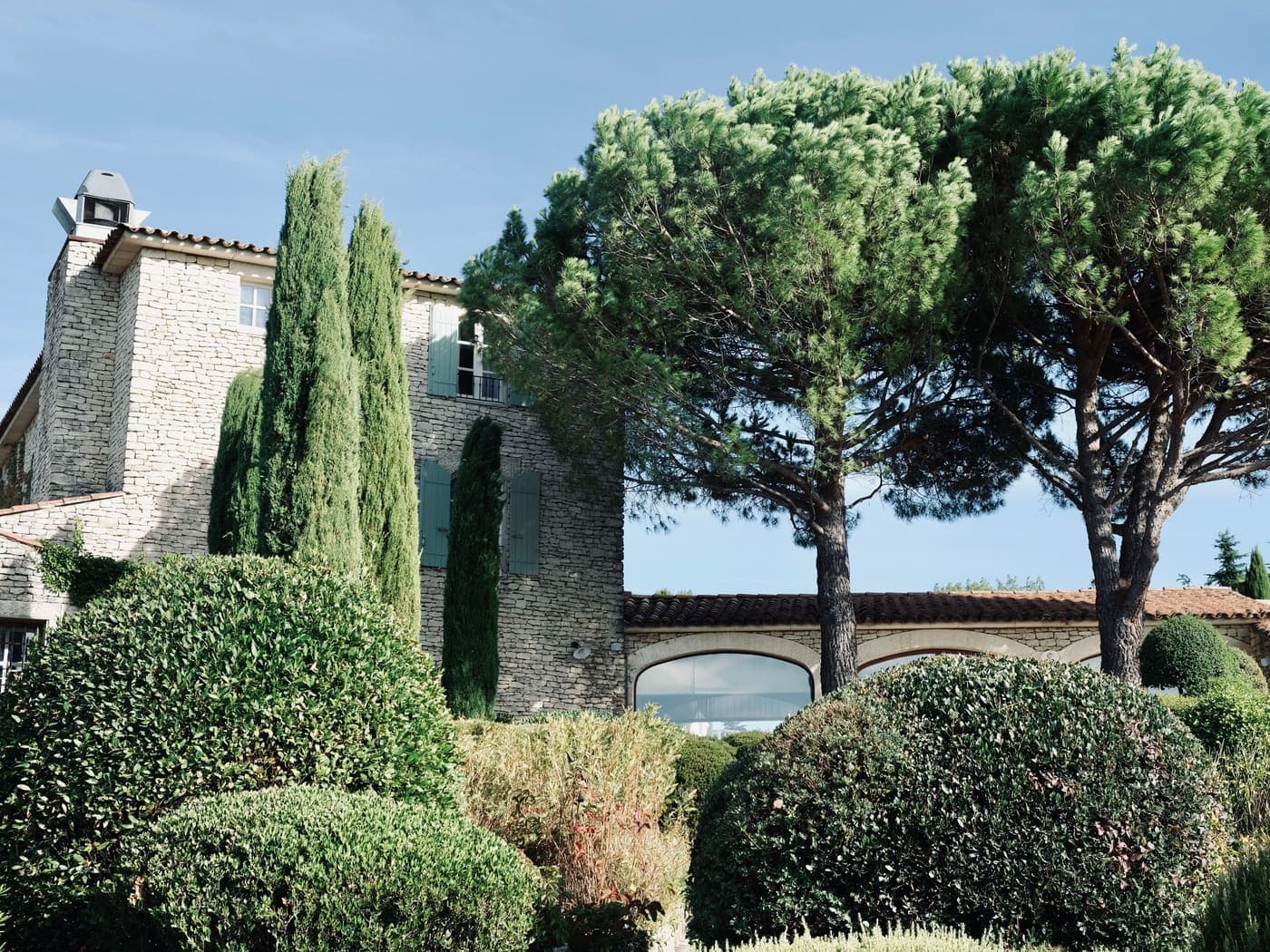Stone bastide with pines and clipped gardens in the Occitanie countryside