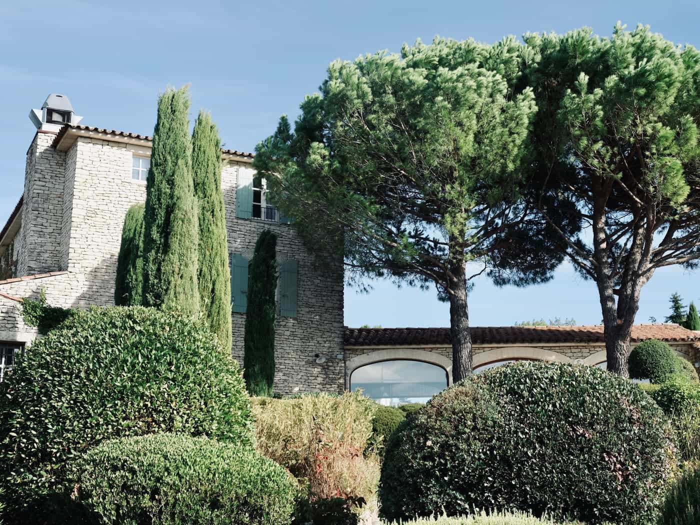 A stone bastide with pines and clipped gardens in the Occitanie countryside